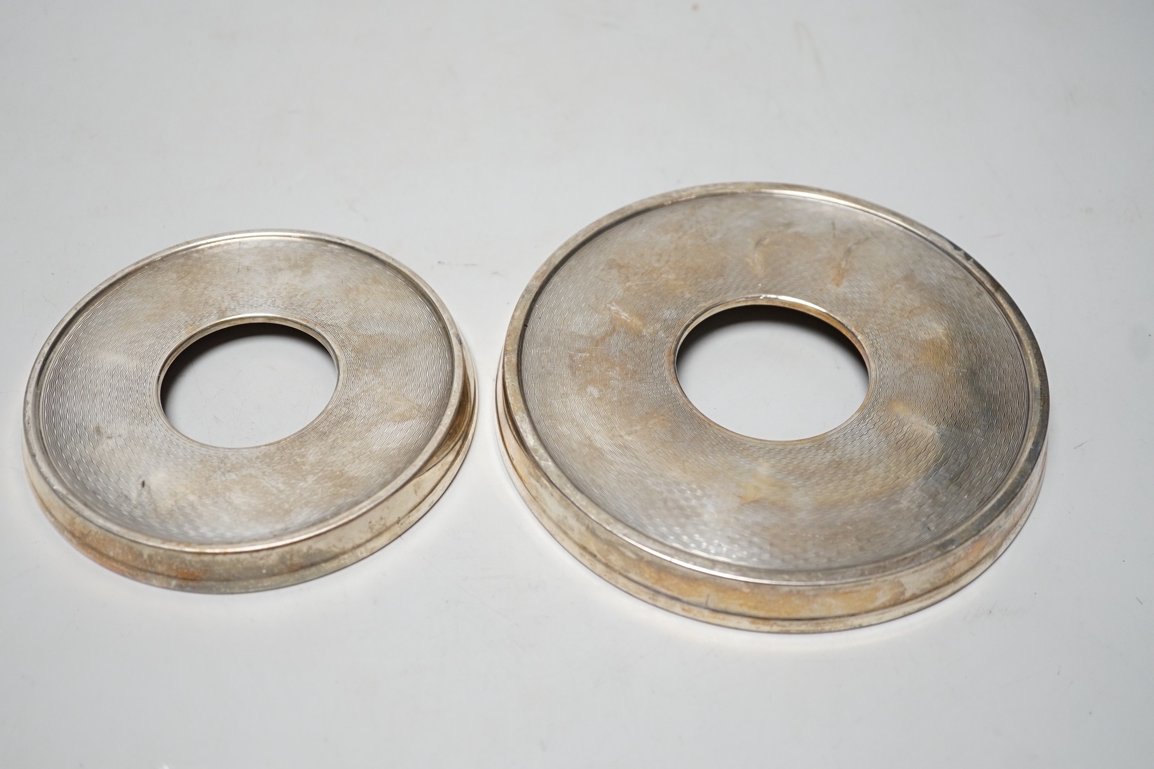 Two 1930's graduated silver mounted faux walnut bottle coasters, Joseph Gloster Ltd. Birmingham, 1935/8, largest diameter 16cm.